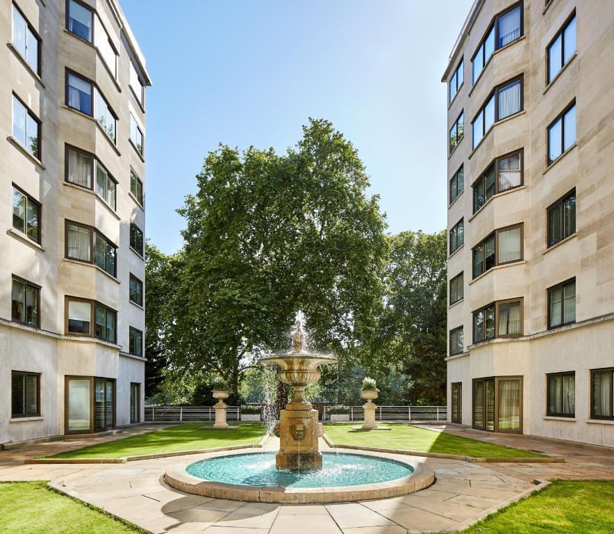 a fountain in the middle of two buildings at Arlington House Apartments in London
