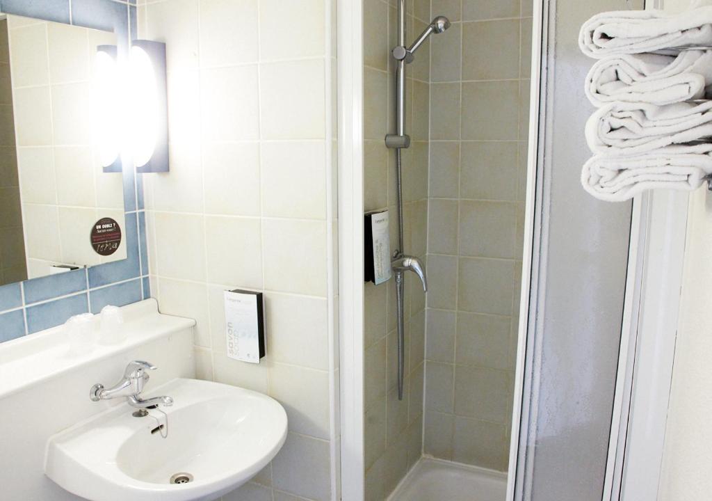 a bathroom with a shower and a sink and a toilet at Campanile Dijon Centre - Gare in Dijon