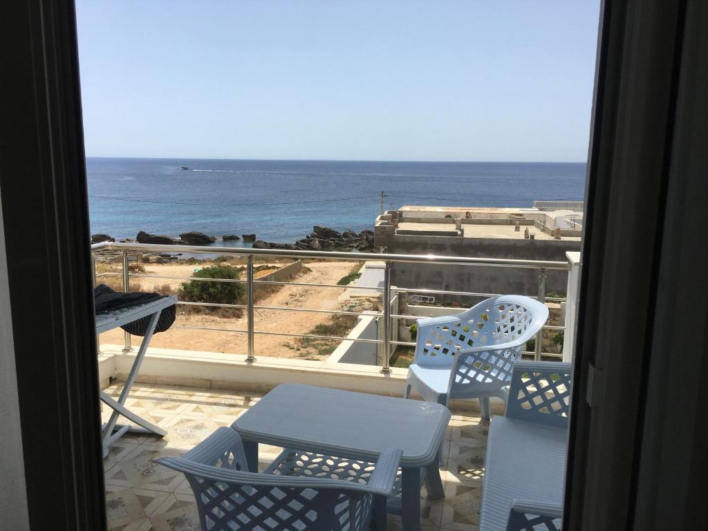 a room with a view of the ocean from a balcony at Arabesque Style - 2 appartements in Kelibia