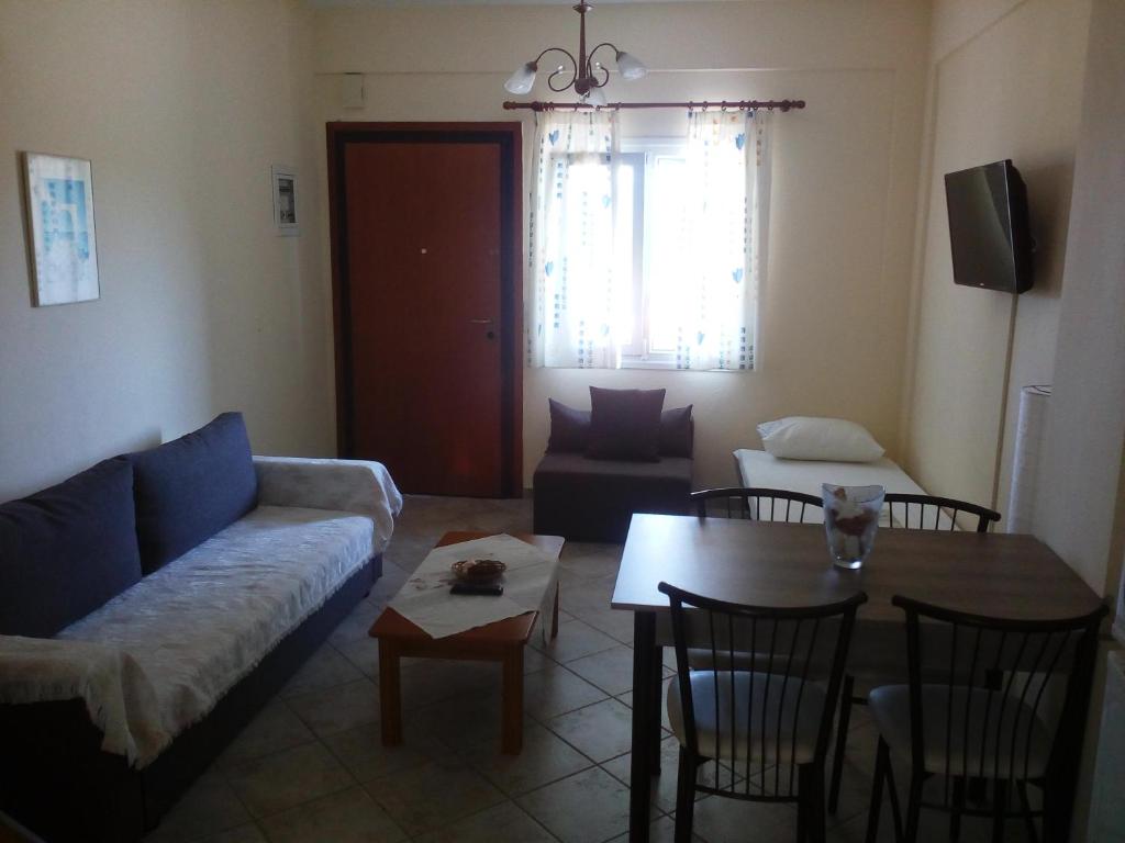 a living room with a couch and a table at Dasea Houses in Ormos Panagias
