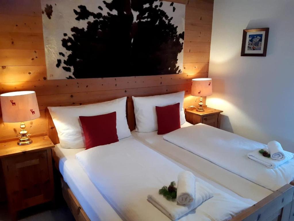 a bedroom with a large bed with two lamps at Haus Reason in Aurach bei Kitzbuhel