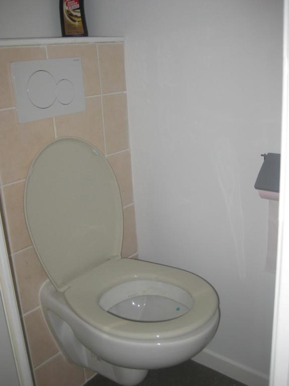a bathroom with a white toilet in a room at La Grande Marée in Dieppe