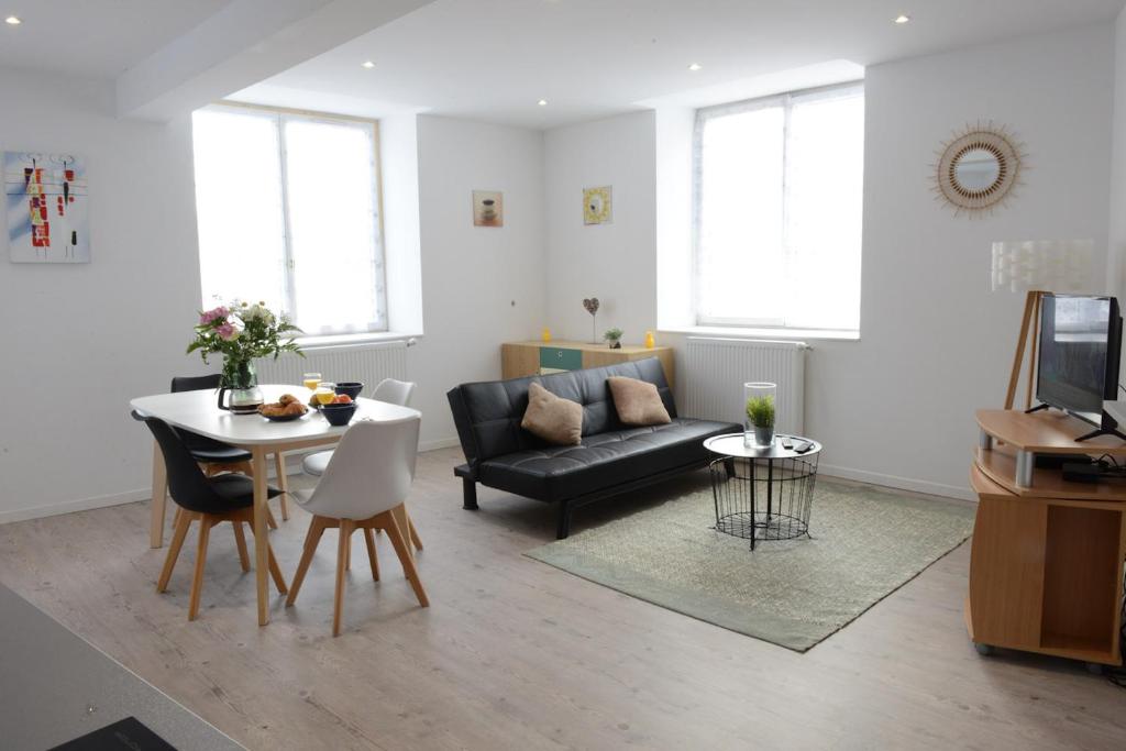 a living room with a couch and a table at Perle Marine in Dieppe