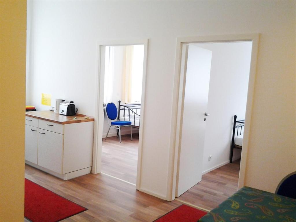 a room with a kitchen and a door leading to a bedroom at Maffei Apartments in Nuremberg