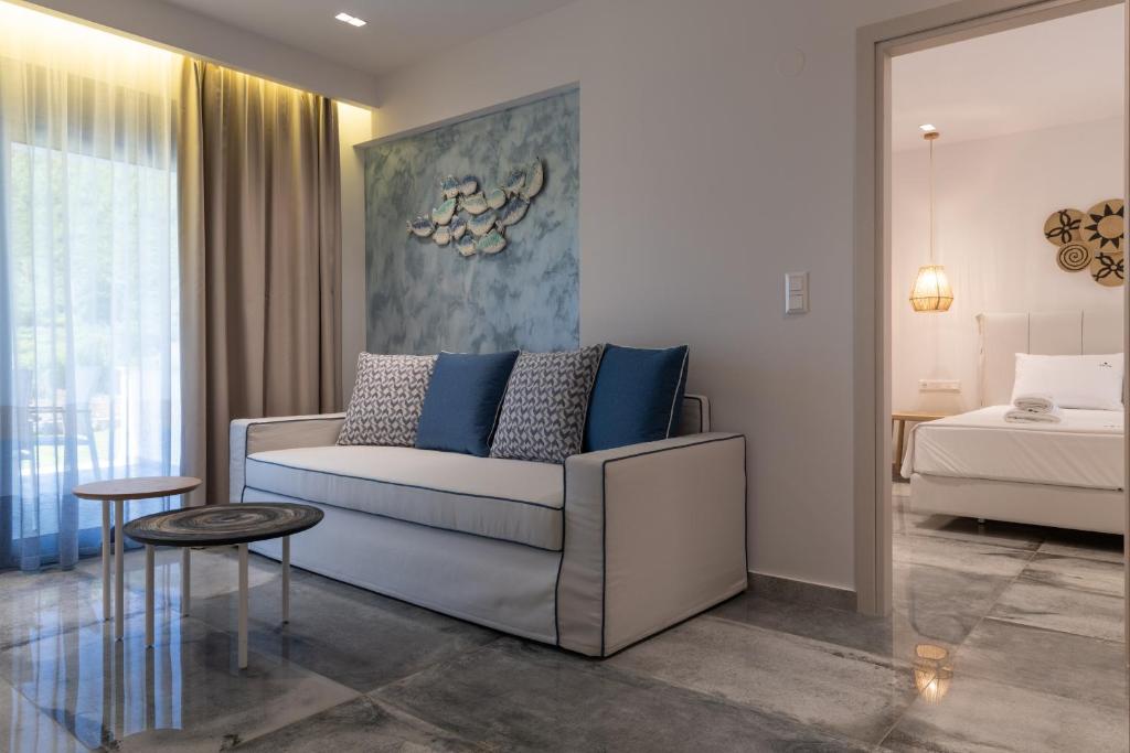 a living room with a couch and a bed at Notia Luxury Living in Porto Koufo