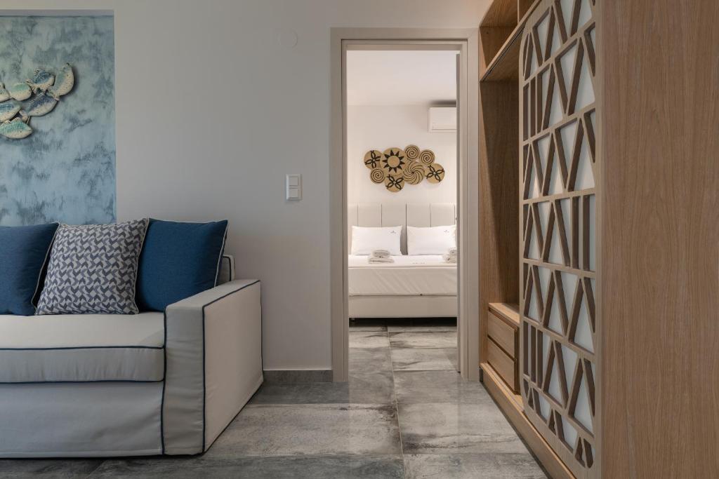 a living room with a couch and a bedroom at Notia Luxury Living in Porto Koufo