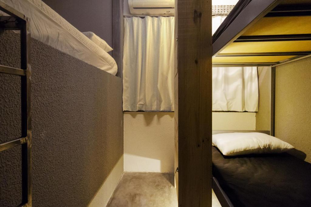 Postel nebo postele na pokoji v ubytování Joy Hostel & Suítes