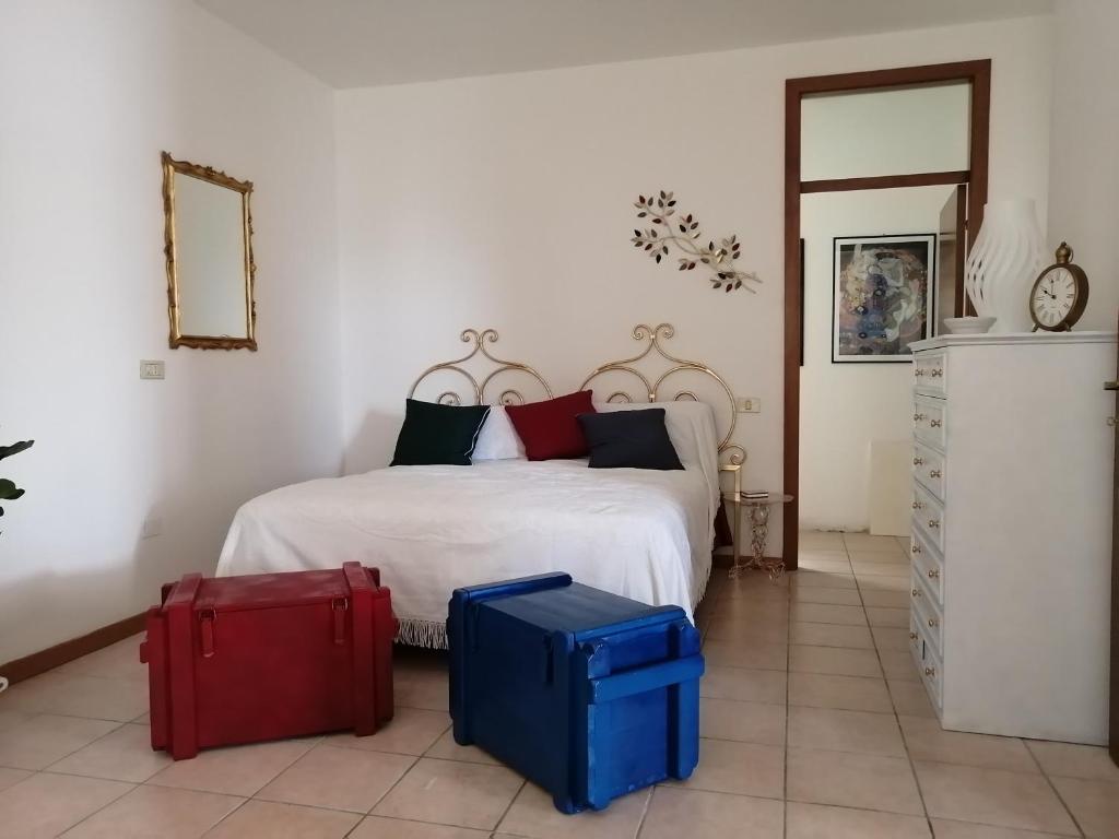 een slaapkamer met een bed met twee koffers op de vloer bij CalaMazzante in Il Palazzone