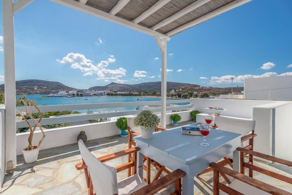 a balcony with a table and chairs and a view of the water at Vista Mare Pollonia in Pollonia