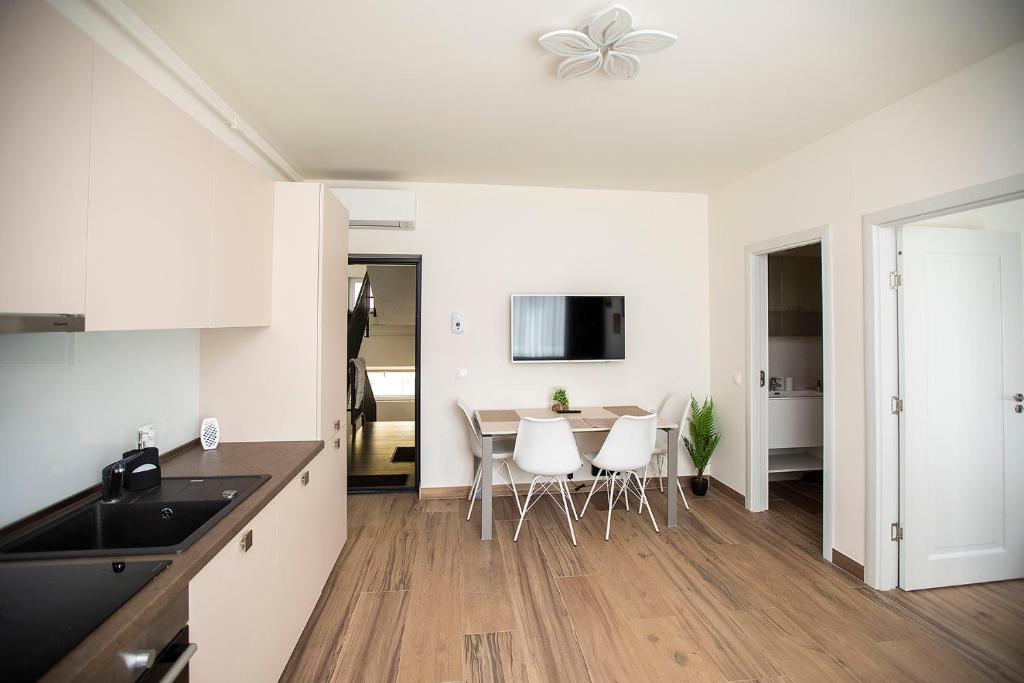 a kitchen and dining room with a table and chairs at Covaciu aparthotel in Cluj-Napoca