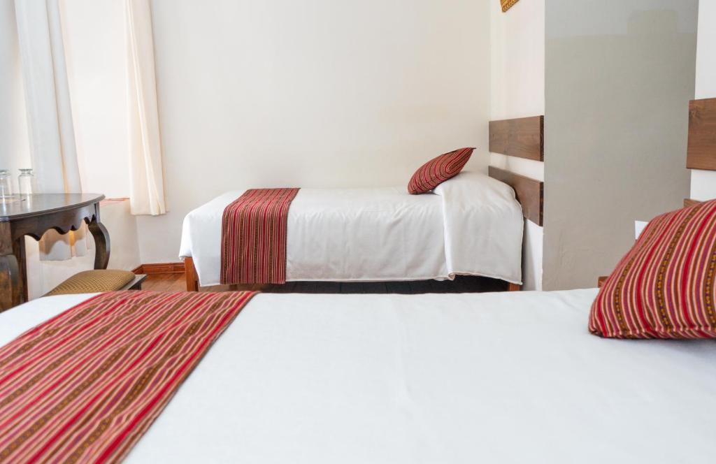 Postel nebo postele na pokoji v ubytování La Casona Real Cusco