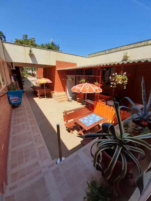 an outdoor patio with a table and an umbrella at Casa Rebeca in Neptun