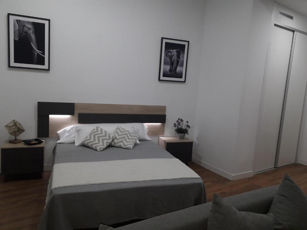 A bed or beds in a room at Pastor Design Suites