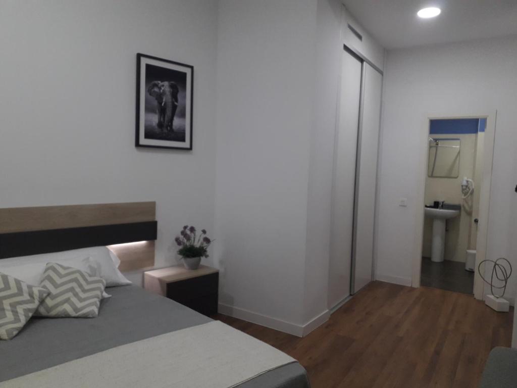 A bed or beds in a room at Pastor Design Suites