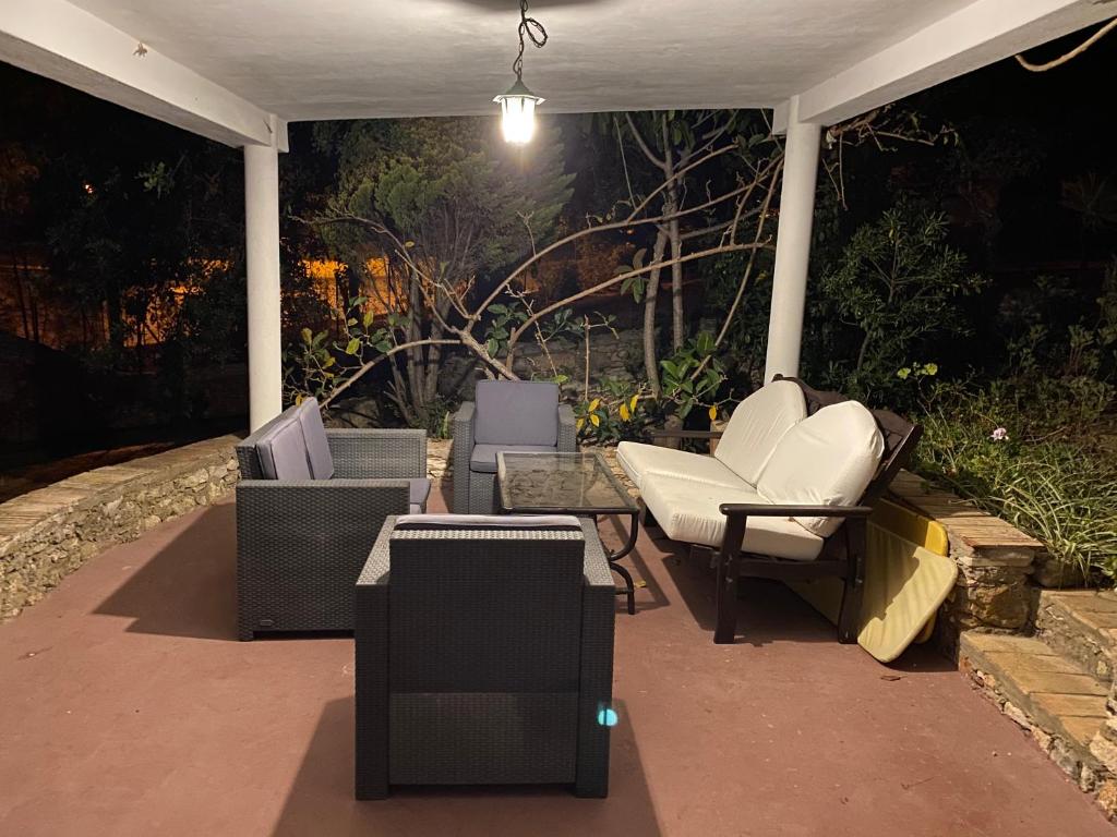 a group of chairs sitting on a patio at night at Casa do Milho in Carvoeiro