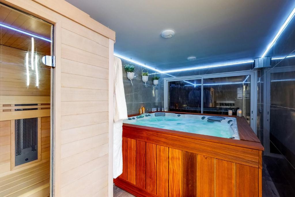 a bathroom with a jacuzzi tub at MickeyRelax - House Spa Sauna next Disneyland Paris in Villeneuve-le-Comte