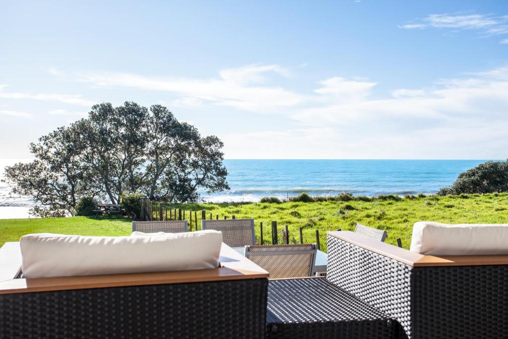 a patio with a view of the ocean at Airi Kainga - Seaside Escape in Te Kaha