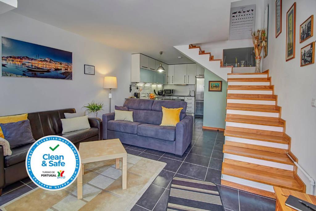 a living room with a couch and a stair case at Bairro Alegre, Casa do Porto in Porto
