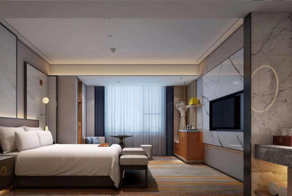 a hotel room with a bed and a television at Ramada by Wyndham Changsha Wuguang in Changsha
