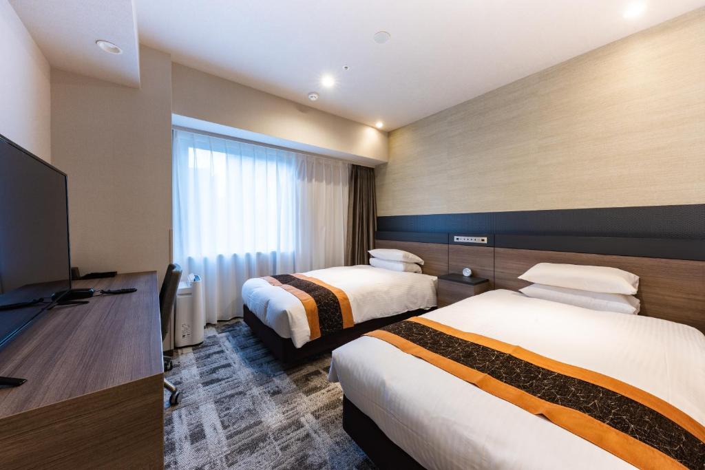Postel nebo postele na pokoji v ubytování Hotel Kazusaya
