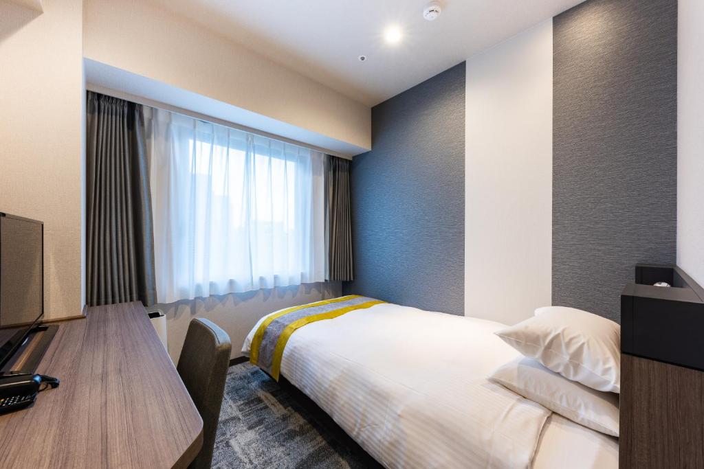 Postel nebo postele na pokoji v ubytování Hotel Kazusaya