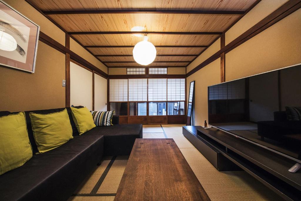 a living room with a couch and a table at Shiki Homes HARU in Kyoto