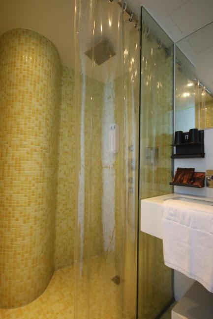 a bathroom with a shower with a glass door at Hotel Papa Whale-Kaohsiung Formosa Boulevard in Kaohsiung