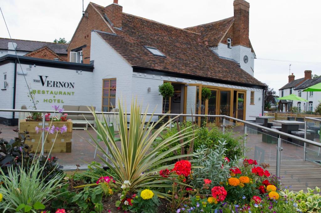 a garden in front of a building with flowers at The Vernon in Droitwich