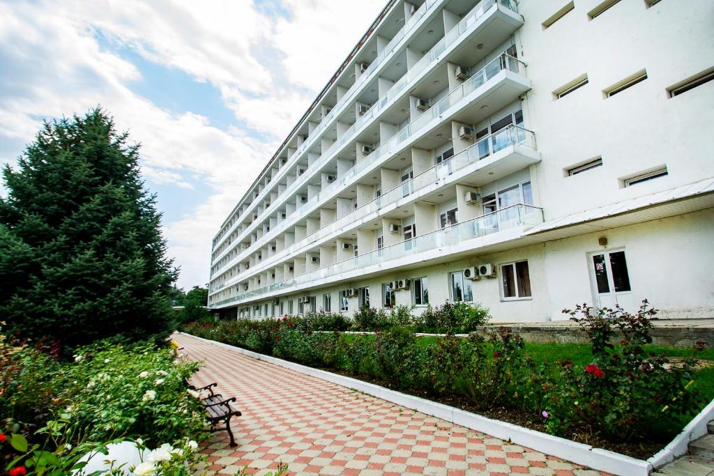 a large white building with a bench in front of it at Sanatoriy Kirova in Pyatigorsk