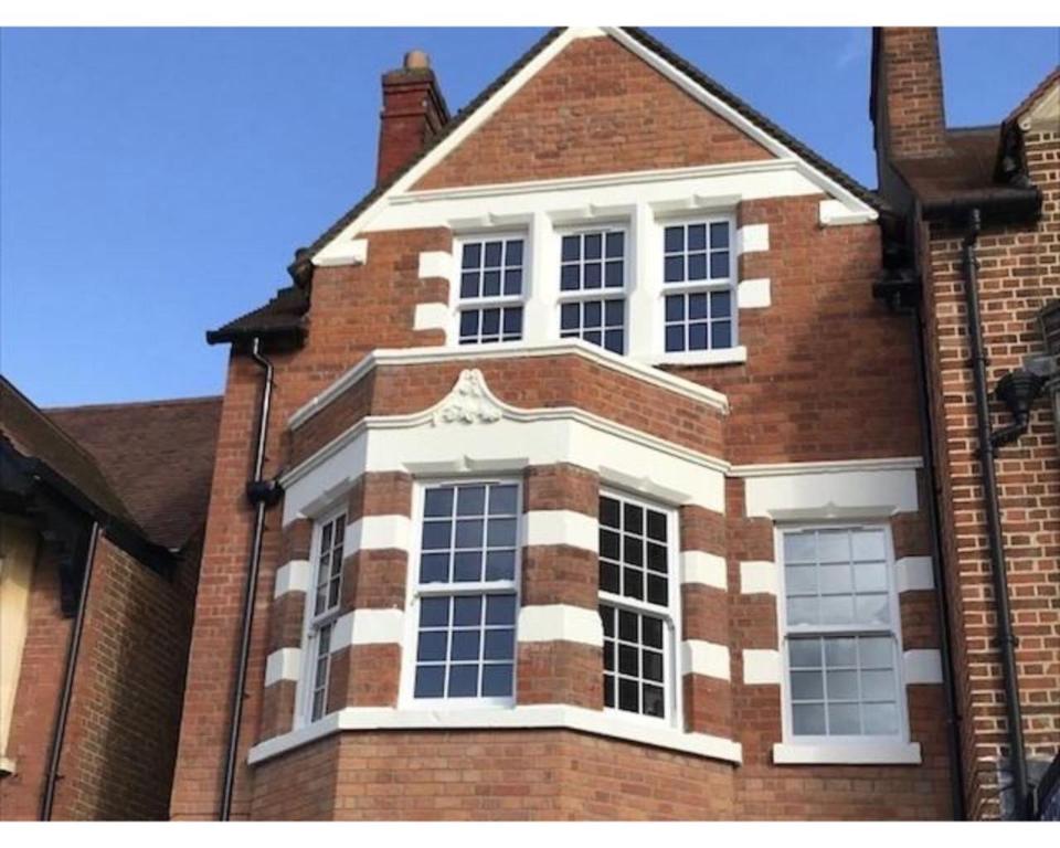 a large brick building with large windows on it at Iffley Town House in Oxford