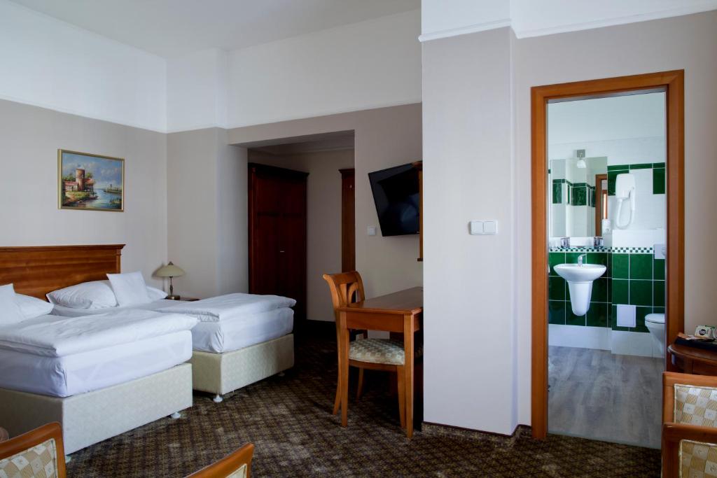 Postel nebo postele na pokoji v ubytování Wellness Hotel Ida