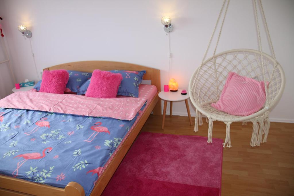 
A bed or beds in a room at Pink Flamingo Nest - unique design apartment
