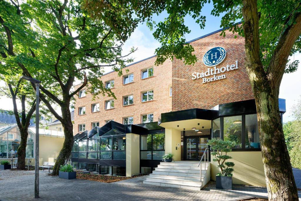 a building with a sign on the front of it at Stadthotel Borken in Borken