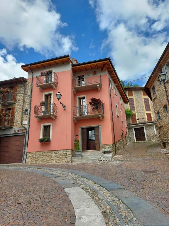 a pink building with balconies on a street at LA MONTADARIA in Zavattarello