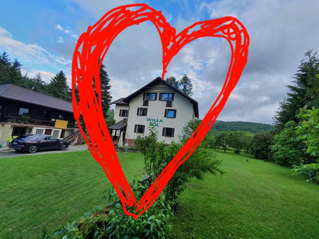 a red heart in front of a house at Willa Sól in Rajcza
