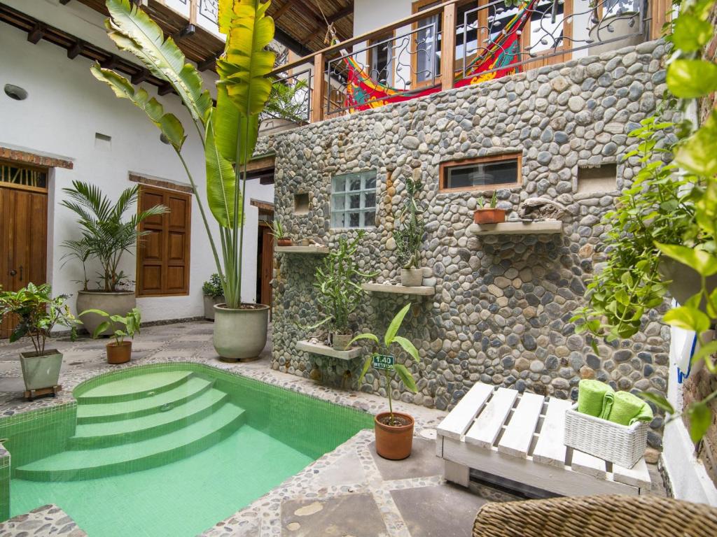 a house with a swimming pool in the yard at Casa Verde Hotel in Santa Marta