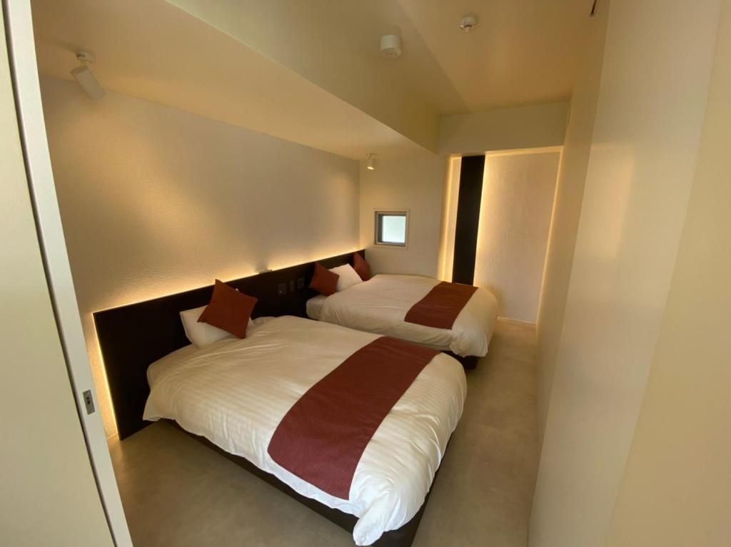 Ein Bett oder Betten in einem Zimmer der Unterkunft KEN KEN VILLA YUUMODORO