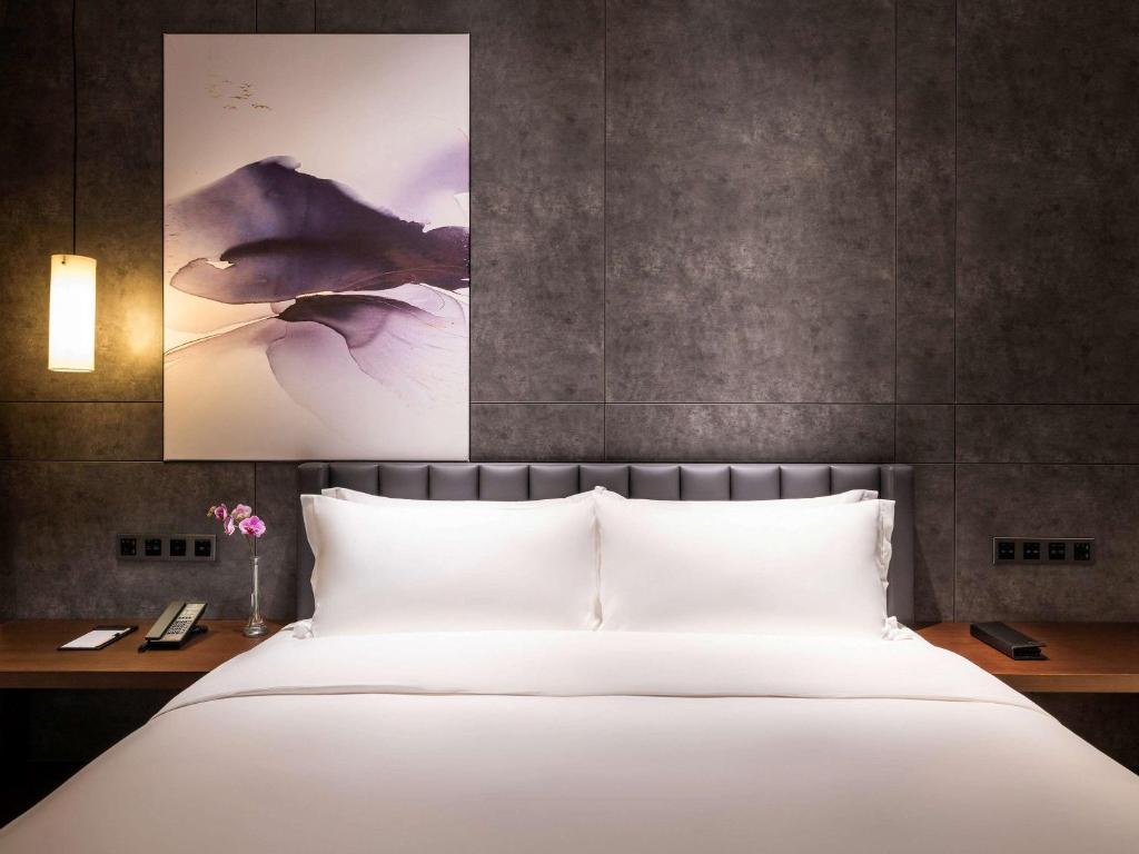 Postel nebo postele na pokoji v ubytování Mercure Shenzhen Longgang