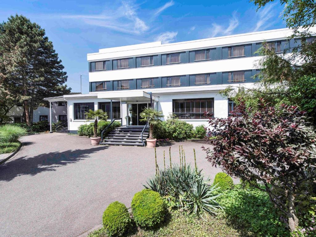 a white building with a courtyard in front of it at ibis Styles Offenburg City in Offenburg