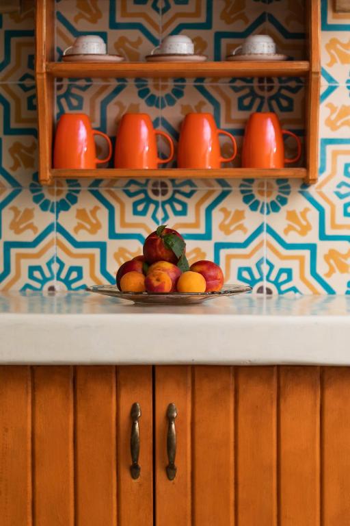 a plate of fruit on a counter in a kitchen at Ta Petrina in Vourvourou