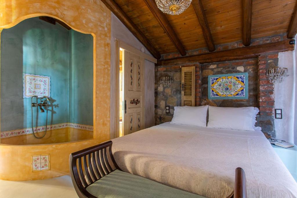 a bedroom with a large bed in a room at Ta Petrina in Vourvourou