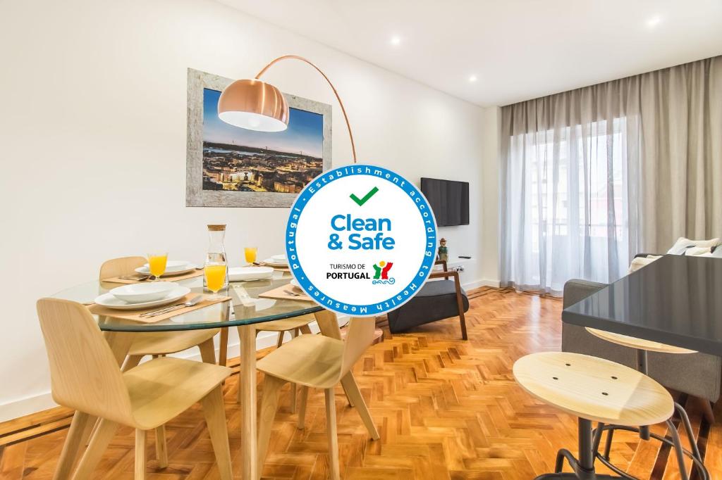 a dining room with a table with a sign that says clean and safe at Marquês de Pombal Metropolitan Flat in Lisbon