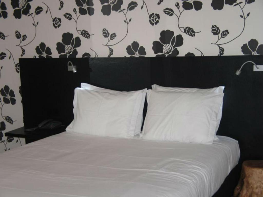 Postel nebo postele na pokoji v ubytování Funchal Design Hotel