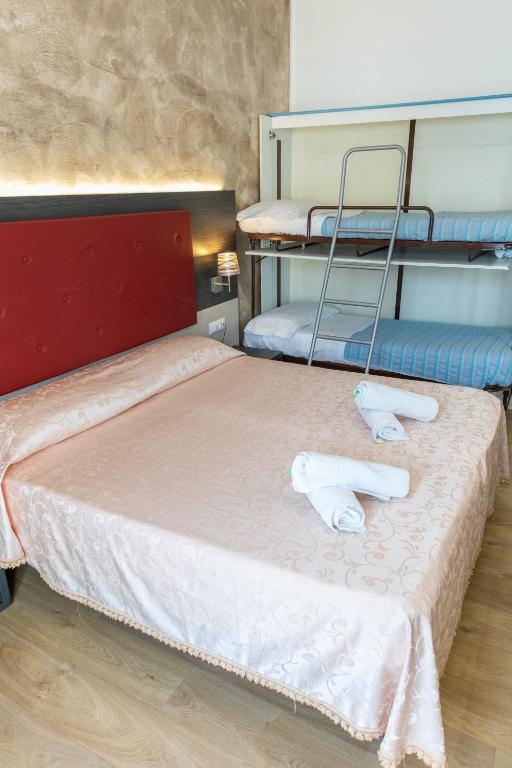 Postel nebo postele na pokoji v ubytování Hotel Verdi