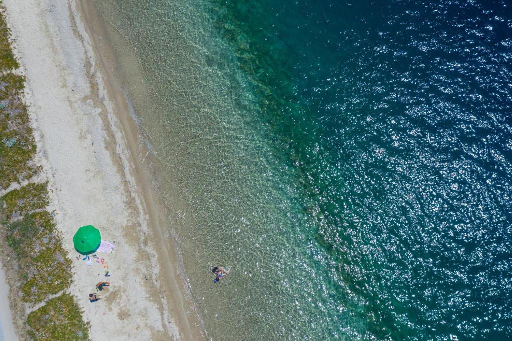 an overhead view of a beach and the ocean at Notia Luxury Living in Porto Koufo