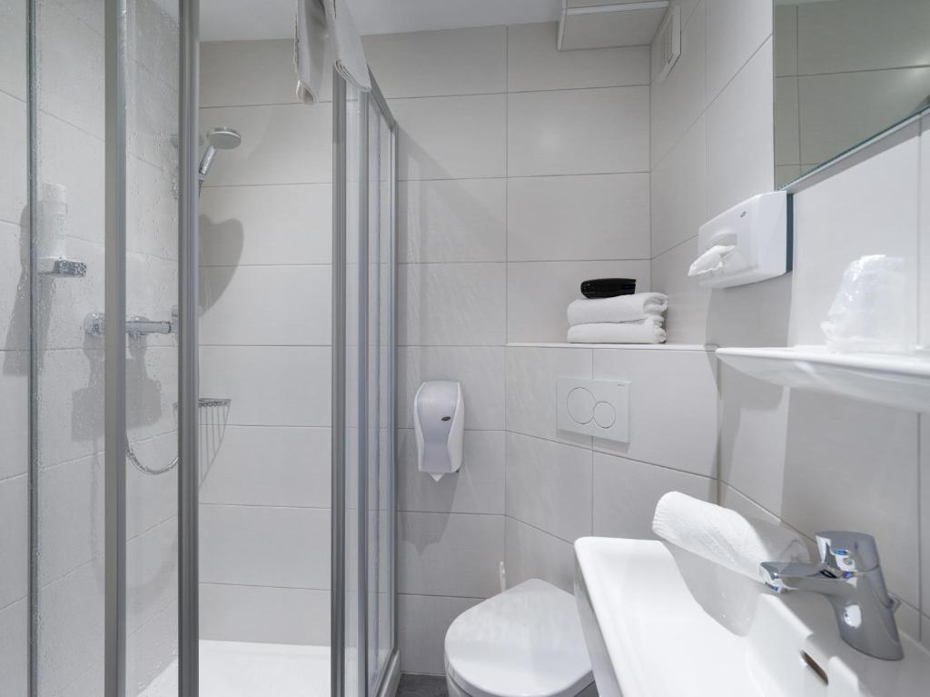 a bathroom with a shower and a toilet and a sink at Haus Tirol in Brixen im Thale