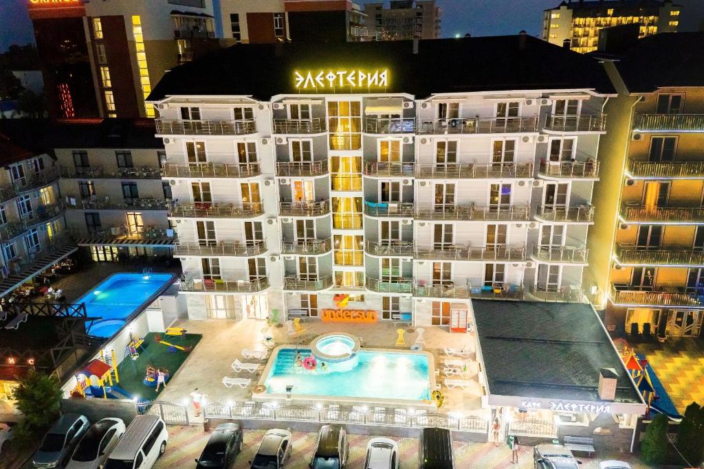 a large building with a swimming pool in front of it at Hotel Elefteriya in Vityazevo