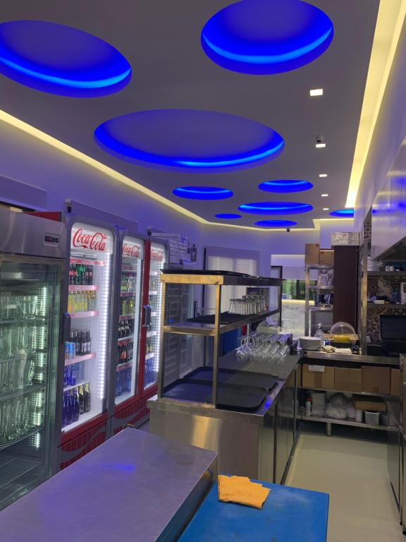 a fast food restaurant with blue frisbees on the ceiling at Vergos Hotel in Vourvourou
