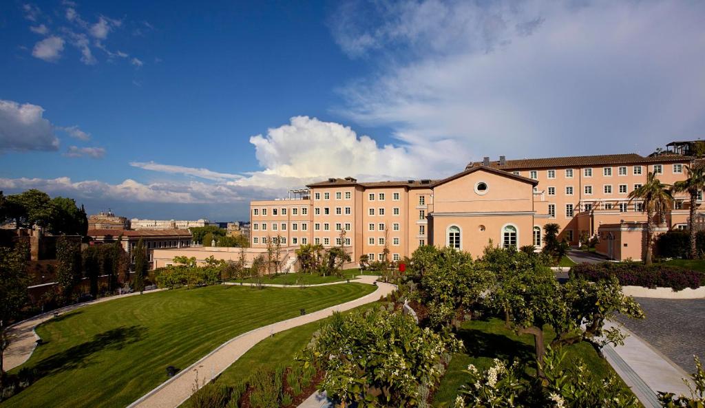 a large building with a clock on the side of it at Villa Agrippina Gran Meliá – The Leading Hotels of the World in Rome