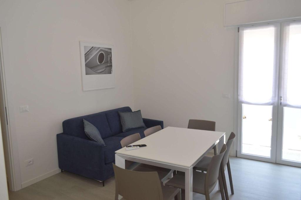 a living room with a blue couch and a table at MAR60 Apartments in Caorle